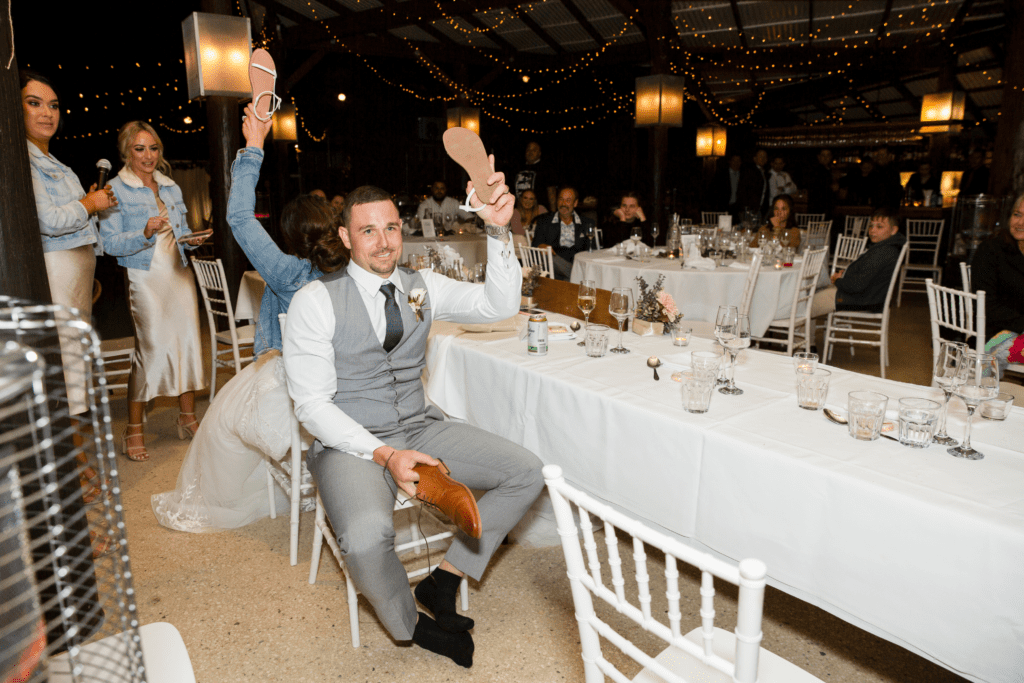 bride and groom playing shoe game during wedding reception