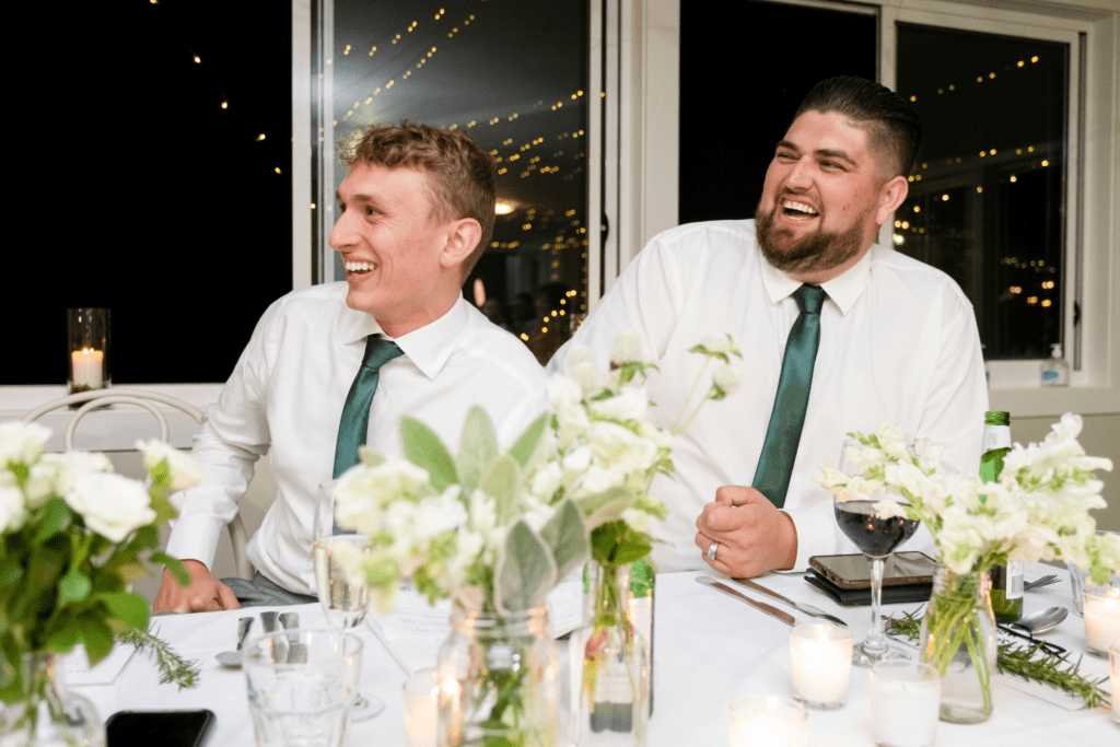 groomsmen laughing during wedding reception speeches at Sublime Point