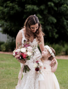Bride and flower girl photographed smiling at Camden NSW wedding