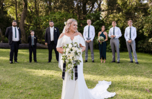 Bride standing in front of wedding party at Sublime Point