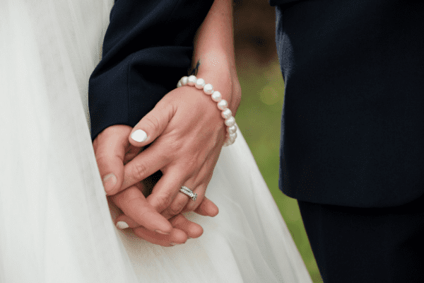 Close up photo of bride and groom holding hands at New South Wales wedding Close up photo of bride and groom holding hands at New South Wales wedding