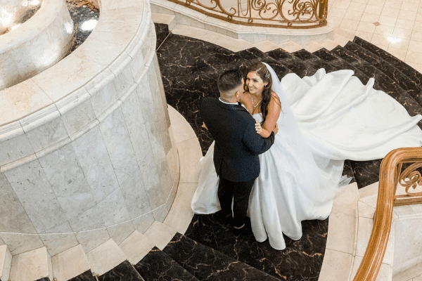 Bride and groom posing for wedding photographer on stairs at Sheldon Reception in Melbourne Bride and groom posing for wedding photographer on stairs at Sheldon Reception in Melbourne