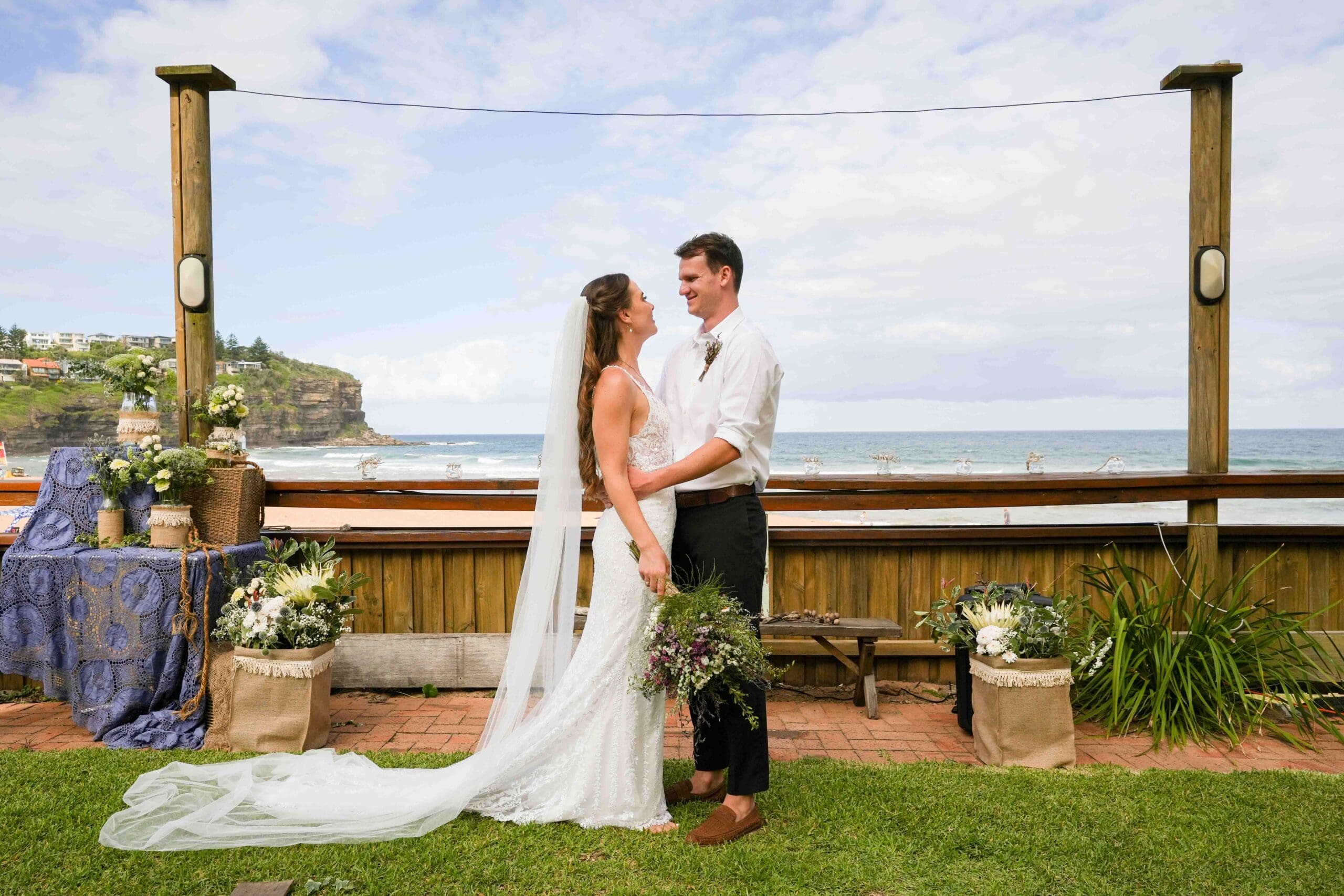 jordan and jack posing for wedding photographer after bilgola beach wedding