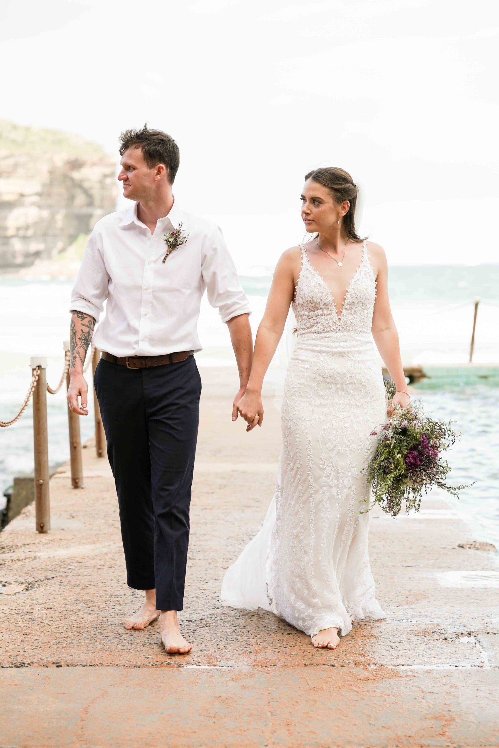 bride and groom holding hands at sunset after Sydney wedding