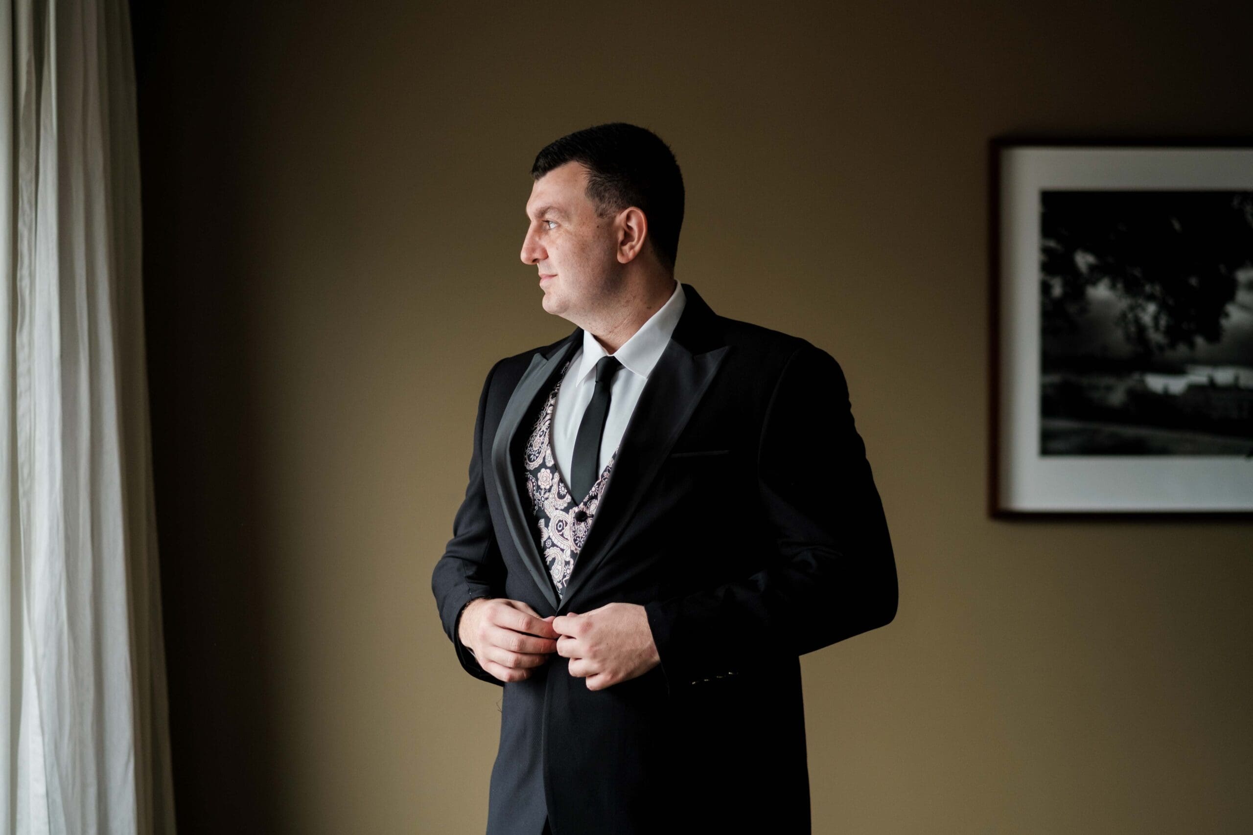 groom posing for wedding photographer