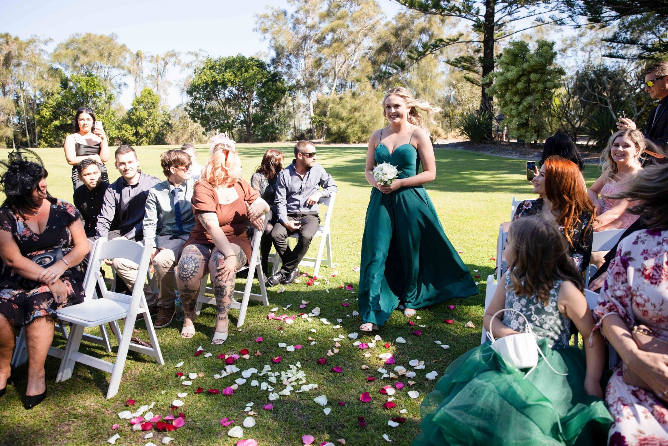 bridesmaid walking down aisle surrounded by confetti
