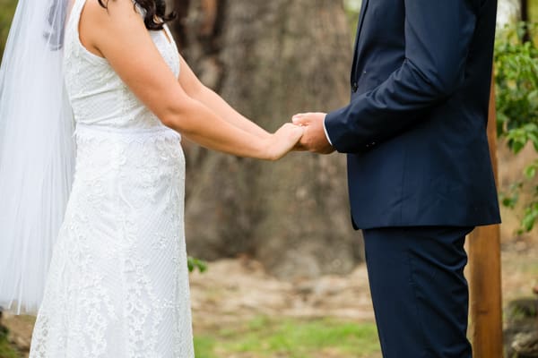 bride and groom holding hands at wedding ceremony in Perth